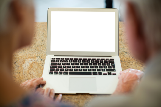 Senior couple using laptop in kitchen