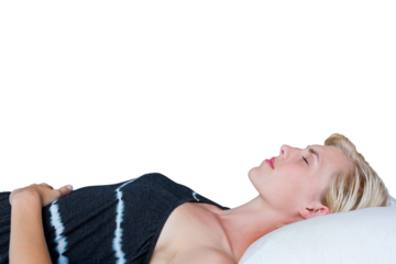 Side view of woman napping on bed