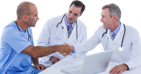 Male doctor and surgeon shaking hands at table