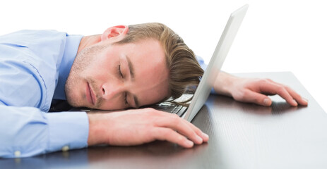 Tired businessman resting head on laptop
