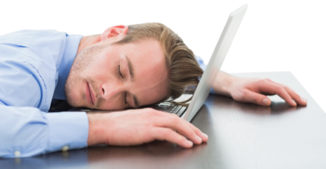 Tired businessman resting head on laptop
