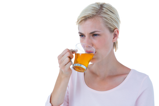 Thoughtful blond woman drinking herbal tea