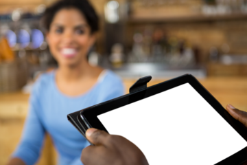 Cropped hands of barista holding digital tablet