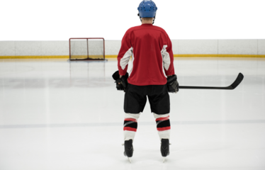 Rear view of hockey player at ice rink