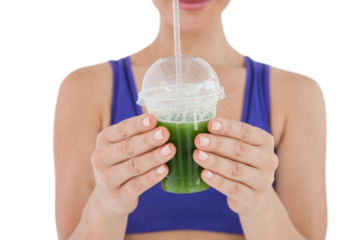 Woman showing green juice in goblet