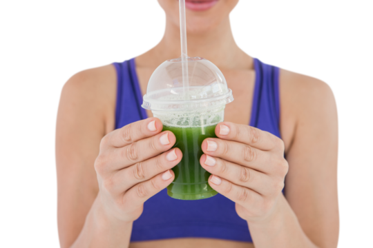 Woman showing green juice in goblet