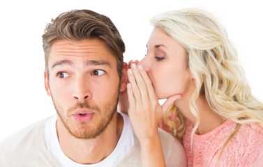 Attractive blonde whispering secret to boyfriend