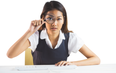 Businesswoman looking through magnifying glass