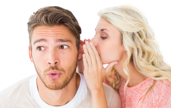 Attractive blonde whispering secret to boyfriend