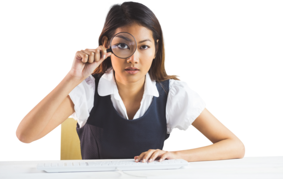 Businesswoman looking through magnifying glass