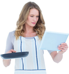 Concentrated woman holding frying pan and tablet pc 