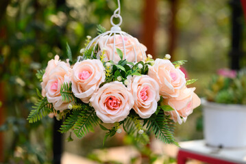 Artificial pink roses flower bouquet hanging and decoration in garden