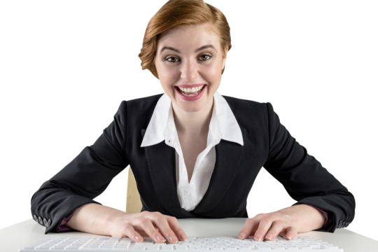 Excited redhead businesswoman sitting at desk - Powered by Adobe