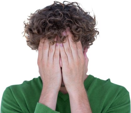 Close-up of upset man covering face with hands