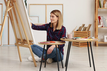 Fototapeta premium Beautiful woman painting in studio. Creative hobby