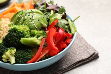 Delicious vegan bowl with bell peppers, avocados and broccoli on table, closeup. Space for text