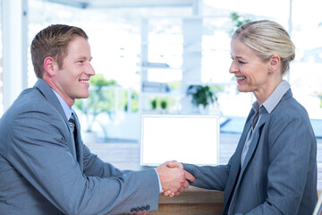 Business people shaking hands in office