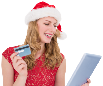 Festive blonde woman using her credit card and tablet pc
