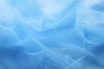 Beautiful light blue tulle fabric as background, closeup