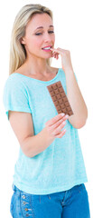 Pretty blonde feeling guilty to eat bar of chocolate