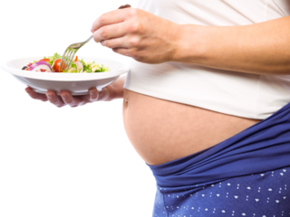 Pregnant woman eating a salad