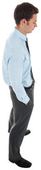 Serious businessman standing with hands in pockets