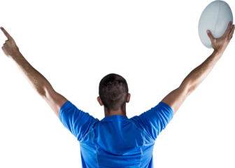 Rear view of rugby player holding ball with arms raised