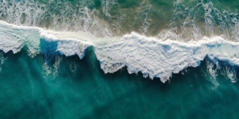 Top-down aerial shot of splashing white waves in the ocean