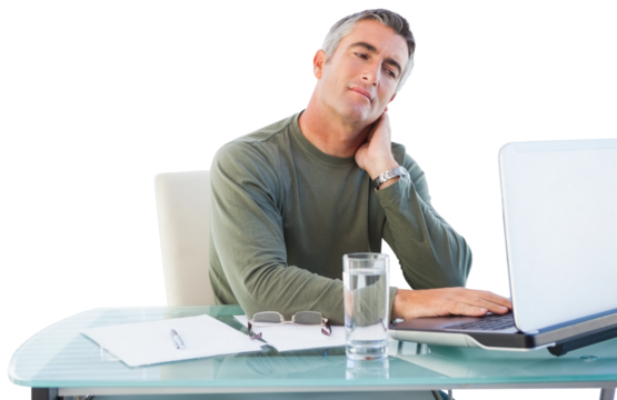 Businessman with neck pain using laptop at desk - Powered by Adobe