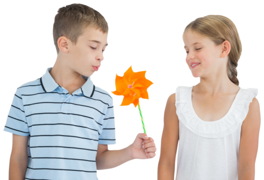 Peaceful brother and sister playing with pinwheel
