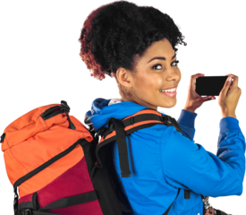 Portrait of young woman with backpack looking back