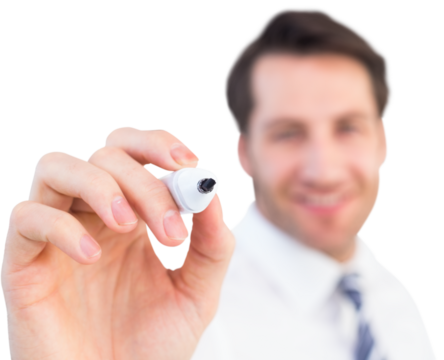 Smiling businessman writing with black marker