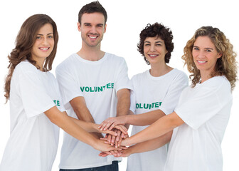 Smiling volunteer group piling up their hands