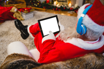 Santa claus using digital tablet at home