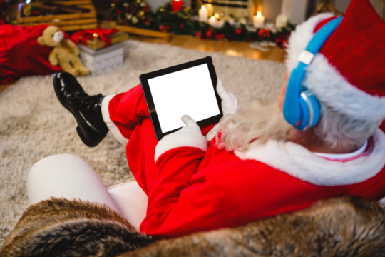 Santa claus using digital tablet at home