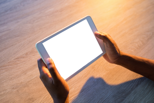 Cropped hands of male executive using digital tablet in office
