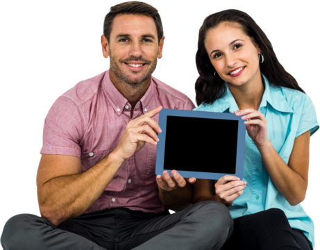 Smiling couple showing tablet at the camera