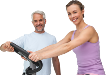 Portrait of a happy woman on stationary bike with trainer