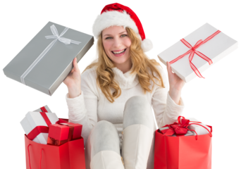 Happy woman sitting on the floor while holding gifts