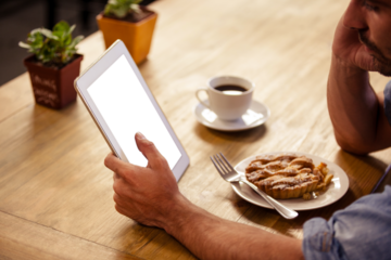 Man looking at digital tablet at cafe