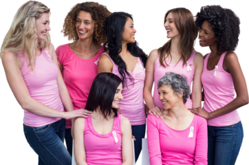 Smiling women in pink outfits posing for breast cancer awareness