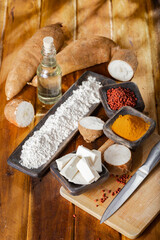 pile of cassava, cassava and cassava flour on a background of rustic wood (Manihot esculenta)