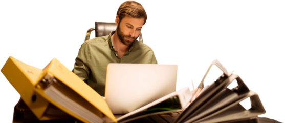 Businessman using laptop whitl sitting at table with files