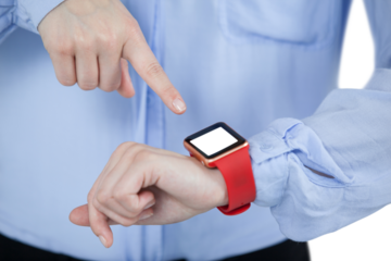 Midsection of businesswoman pointing at smart watch