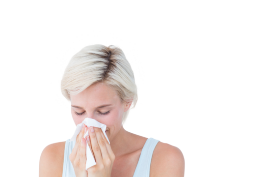 Sick woman blowing her nose