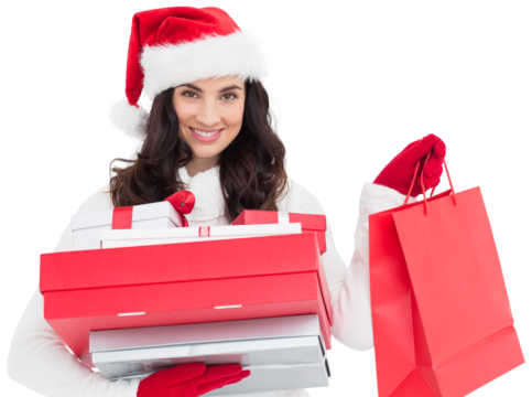 Festive brunette holding christmas gifts and shopping bags - Powered by Adobe