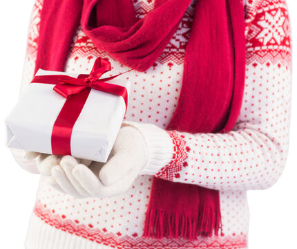 Close up of a festive brunette holding a gift