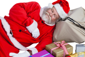 Santa Claus sleeping beside Christmas presents