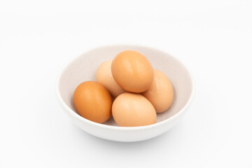 Eggs in white bowl on white background