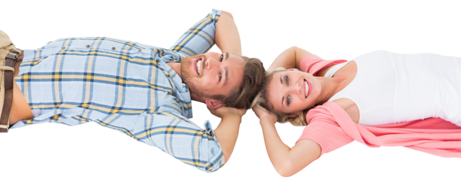 Attractive young couple lying smiling at camera